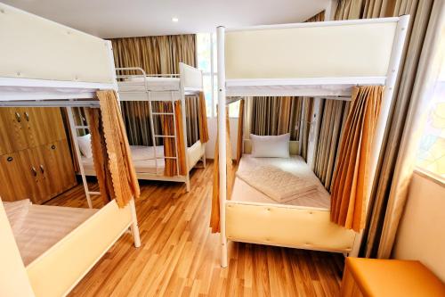 a room with three bunk beds in it at City Backpackers Hostel in Ho Chi Minh City