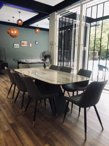 a dining room table and chairs in a room at Maxxim Rainforest Retreat - Rawang in Rawang