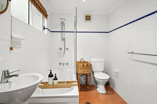 a bathroom with a shower and a sink and a toilet at Peacefully Uphill 2-bed Home with Gorgeous Seaview in Copacabana