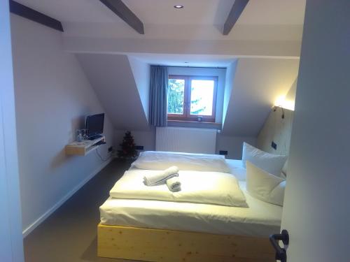 a bedroom with a large bed with a window at Berghotel Pöhlberg in Annaberg-Buchholz