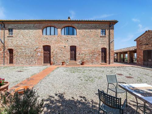 a stone house with two chairs in front of it at Peccioli Villa Retreat w Pool in Peccioli