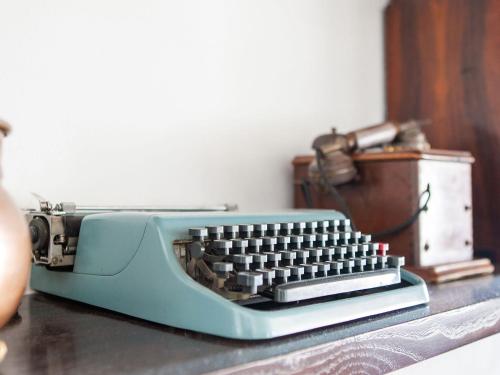 a blue computer keyboard sitting on top of a table at Peccioli Villa Retreat w Pool in Peccioli