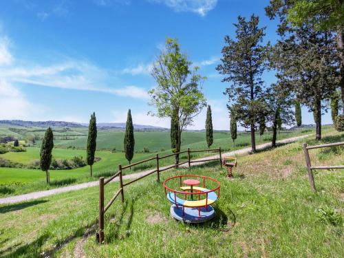 a boat in a field with a fence and trees at Peccioli Villa Retreat w Pool in Peccioli