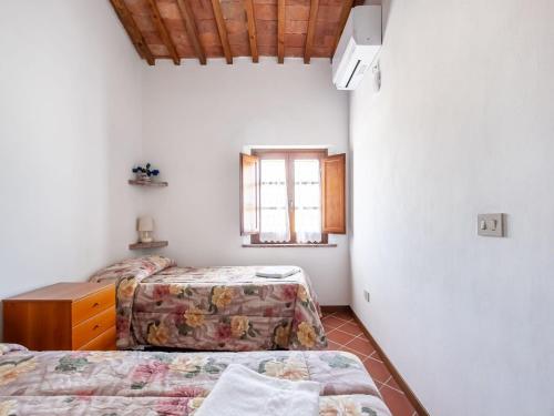 a bedroom with two beds and a window at Peccioli Villa Retreat w Pool in Peccioli