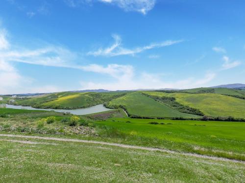 a view of a green valley with a river at Peccioli Villa Retreat w Pool in Peccioli
