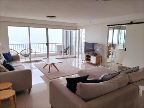 a living room with two couches and a television at Marriner Views in Gold Coast