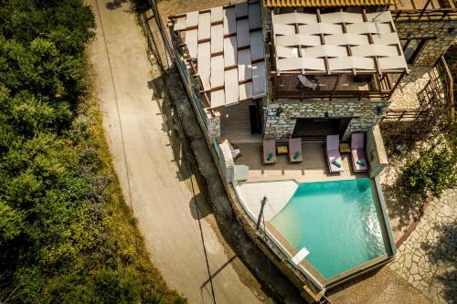 an overhead view of a house with a swimming pool at Villa Diamante -Seafront Stone Villa for 5 with Stunning Sunset Views By Villa Mana Gers in Amoudi