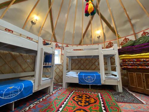 a room with two bunk beds in a yurt at Tunduk Hostel in Bishkek