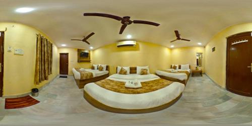 a large room with two beds in it at Hotel Babua Hyness By Avadhesh Group Of Hospitality in Haridwār