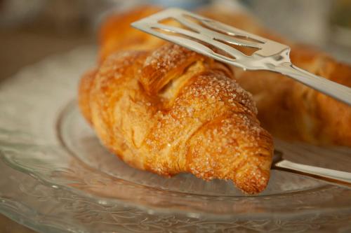 a fork holding a piece of food on a glass plate at Locanda San Bernardo in Vigevano