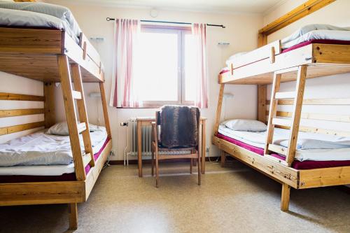 a room with three bunk beds and a window at Renfjällsgården in Edsåsdalen