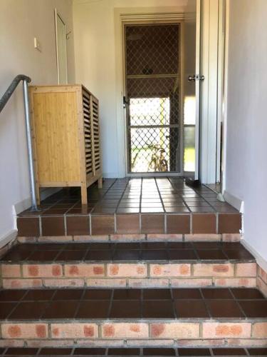 an entrance to a house with a door and stairs at Close to lake, golf & beach, perfect for long stay in Toukley