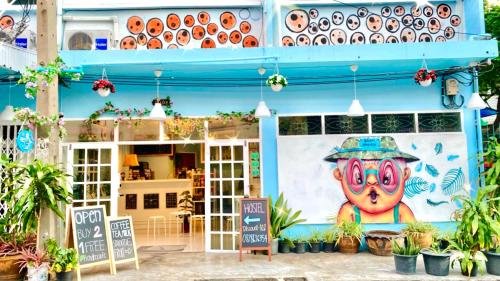 a building with a painting on the side of it at 4J Lodge in Bangkok