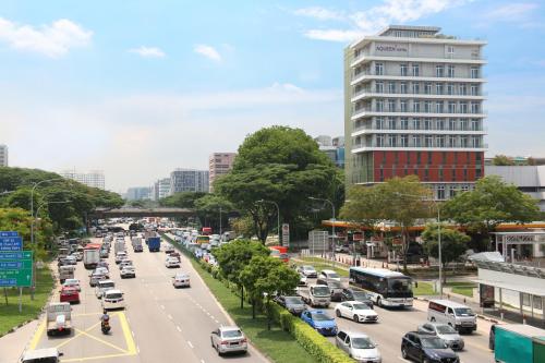 a busy city street filled with lots of traffic at Aqueen Hotel Paya Lebar in Singapore