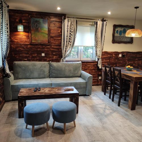 a living room with a couch and a table at Ostoja nad potokiem Dwernik in Dwernik