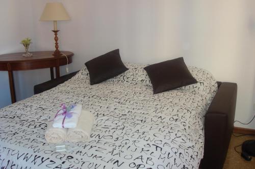 a bed with two pillows and two towels on it at Apartment Bruno's in Rome