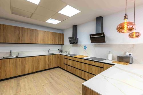 a large kitchen with wooden cabinets and stainless steel appliances at Residencia Demar in Godella