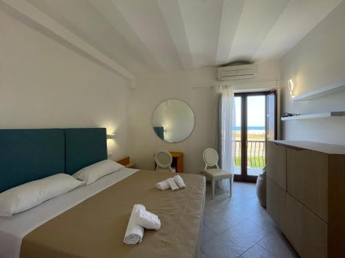 a bedroom with a bed with two towels on it at MARE NOSTRUM in Fasano