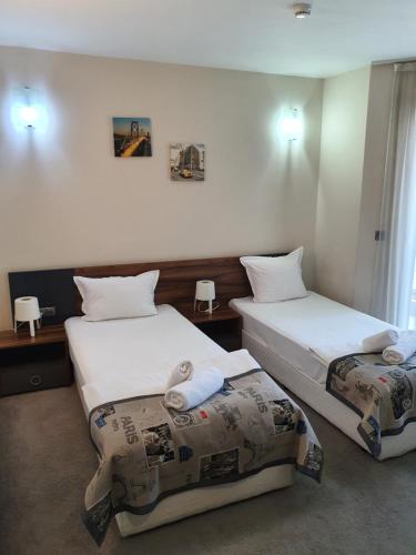 a hotel room with two beds in a room at Family Hotel Novel City in Burgas
