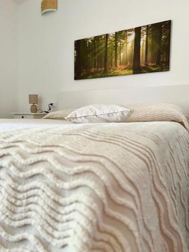 a bedroom with a bed with a television on the wall at Tra Terra e Mare in Flumini di Quartu
