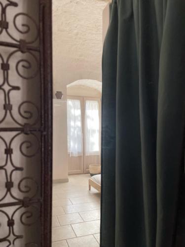 a room with a window and a door with a mirror at La Mia Lamia in Cisternino