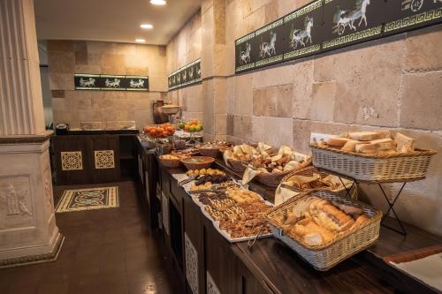 a buffet line with many different types of bread at Buyuk Truva Hotel in Canakkale