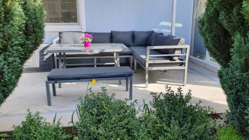 a patio with a couch and a table and chairs at Pension Hackbarth in Beilngries