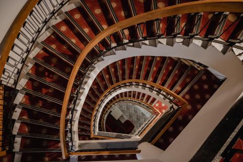 an overhead view of a spiral staircase with wine bottles at Buyuk Truva Hotel in Canakkale