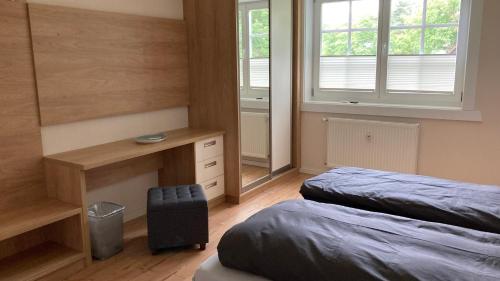 a bedroom with two beds and a desk and window at Ferienhaus Spreewald direkt am Wasser in Burg Kauper