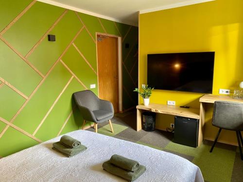 a bedroom with a bed and a desk and a television at Veeriku Villa in Tartu