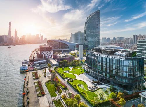 an aerial view of a city with a river and buildings at Prodor Hotel Shanghai in Shanghai