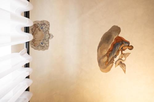 a painting of a fish on a wall at Dome in Catania