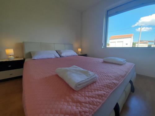 um quarto com uma cama com duas almofadas em Apartment Dominik-Posedarje em Posedarje