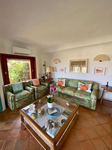 a living room with two couches and a coffee table at Seaview Apartment in Porto Cervo in Porto Cervo