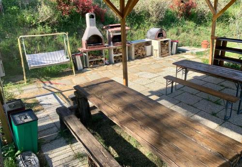 a picnic bench and a grill in a backyard at Il Podere di Massi in Barberino di Mugello