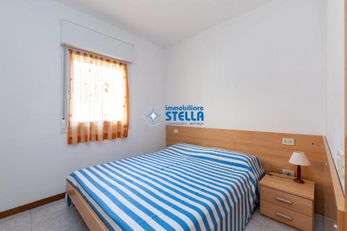 a small bedroom with a bed and a window at Residence Adriatica in Lido di Jesolo