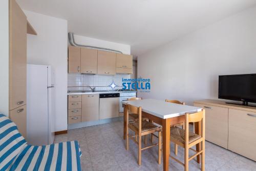 a kitchen with a table and some chairs in a room at Residence Adriatica in Lido di Jesolo