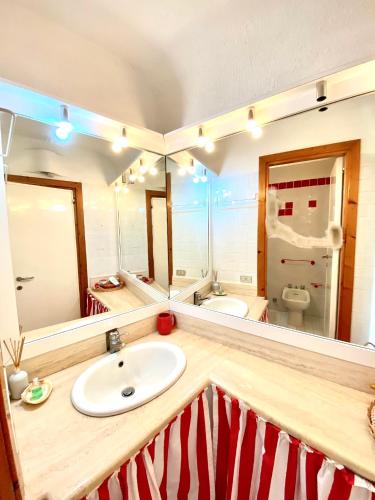 a bathroom with a sink and two mirrors at Seaview Apartment in Porto Cervo in Porto Cervo