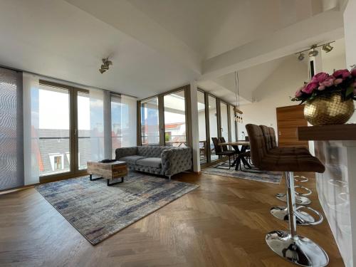 a living room with a couch and a table at Modernes Apartment An der Frauenkirche II in Dresden