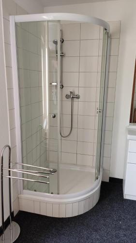 a shower with a glass door in a bathroom at Ferienwohnung in Rathenow in Rathenow