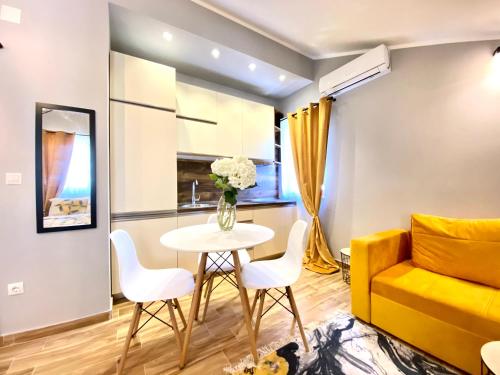 a living room with a table and a yellow couch at Villa Blanca in Risan
