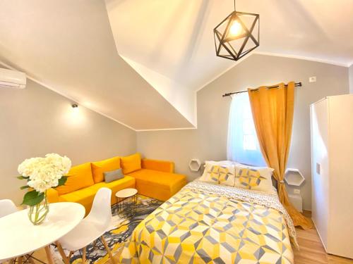 a bedroom with a bed and a couch and a table at Villa Blanca in Risan
