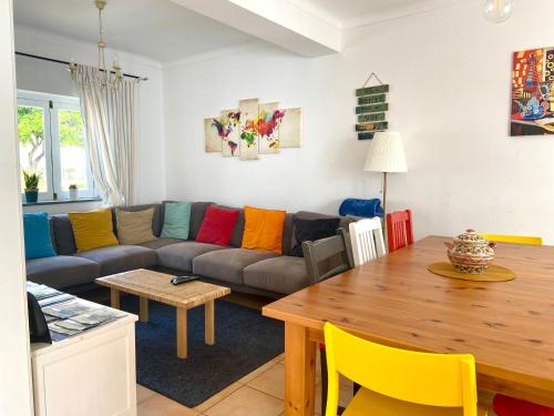 a living room with a couch and a table at Pirata hostel Milfontes in Vila Nova de Milfontes