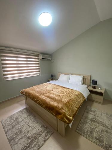 a bedroom with a large bed and a window at Cozy GuestHome Korce in Korçë