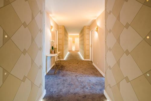 a hallway with yellow and white walls and a room with a table at HafenHotel PommernYacht in Ueckermünde