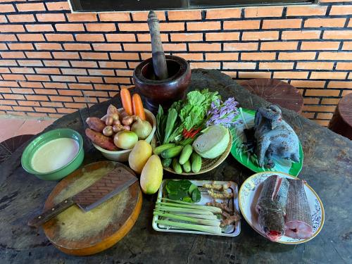 a table with a variety of food on it at Sothea Angkor Homestay in Phumi Ta Phul