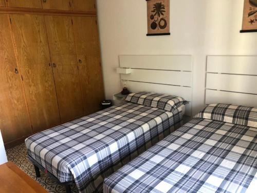 Postel nebo postele na pokoji v ubytování Appartamento Perco Riva Foscolo