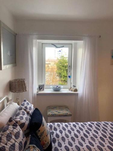 a bedroom with a bed and a window at The Thin Seagull 4 Beacon Terrace Ferryden in Ferryden