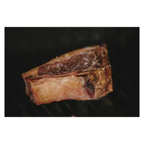 a piece of meat is cooking on a grill at Can Arabí - Adults Only in Ibiza Town