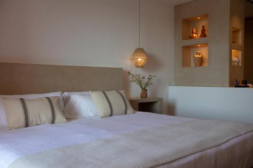 a white bed sitting in a bedroom next to a window at Can Arabí in Ibiza Town